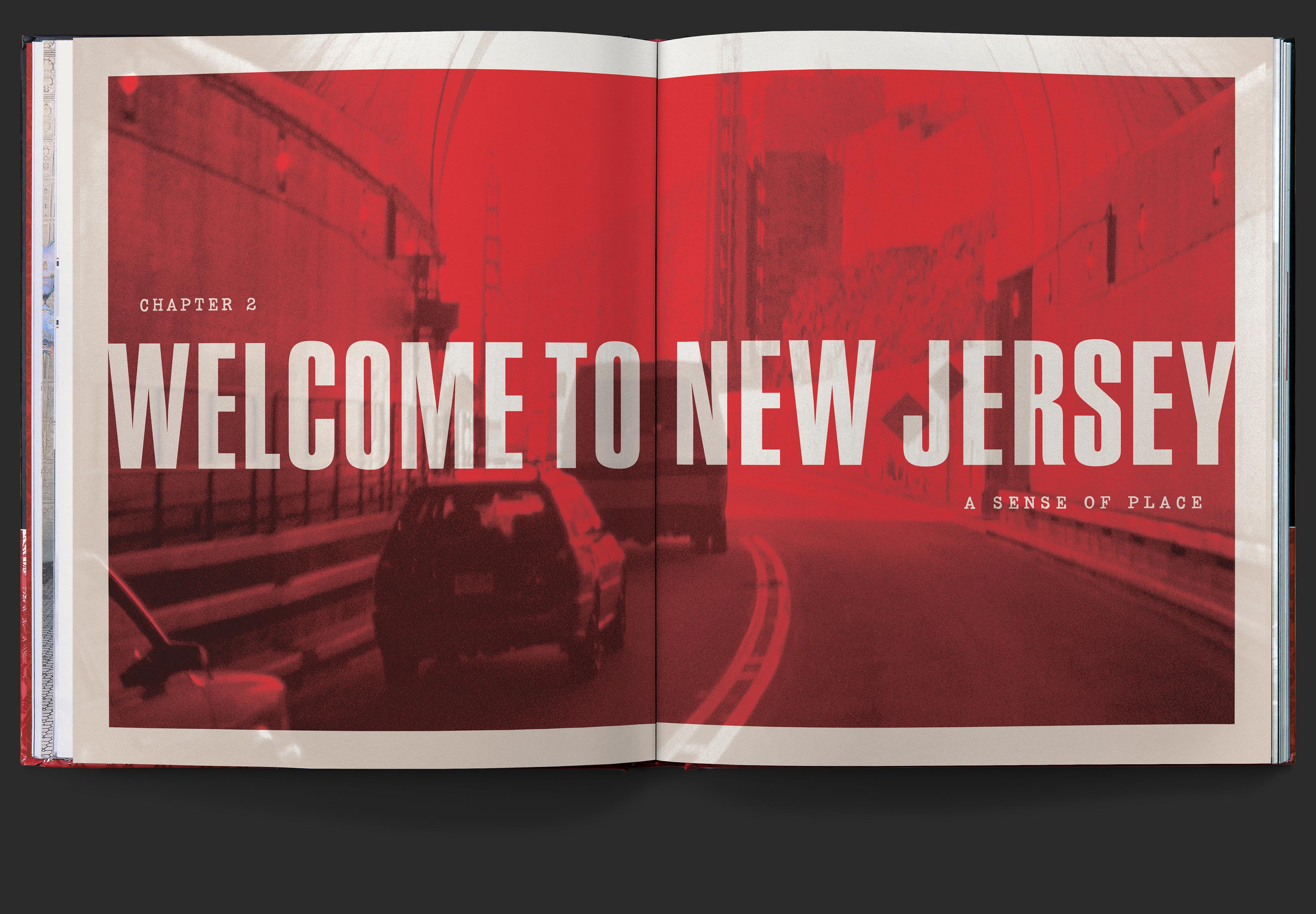 Chapter two opening spread with colorized photo of cars driving with type knocking out, reading, Welcome to New Jersey, a sense of place, printed in bright red and black on white.