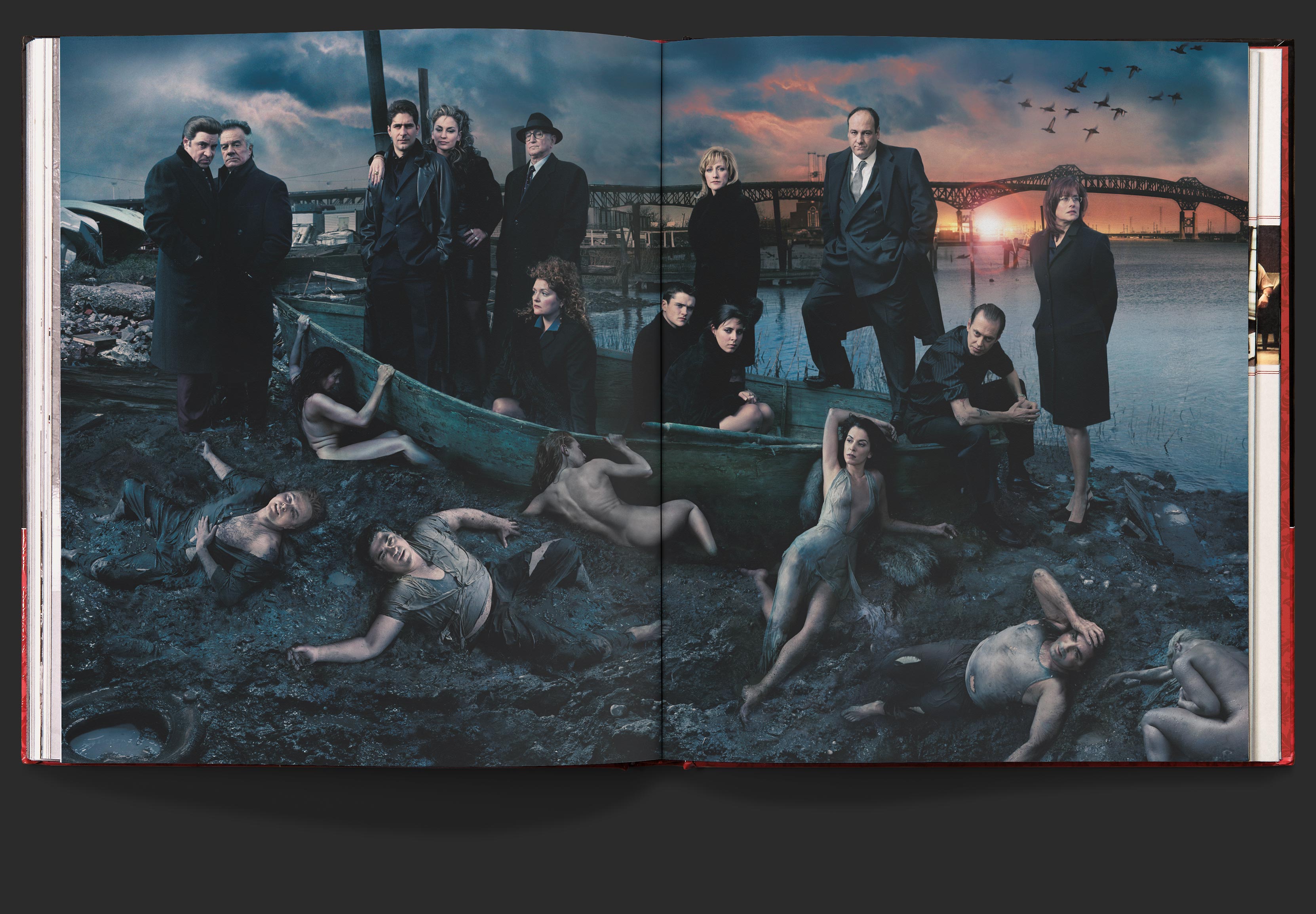 Full bleed portrait of the sopranos cast on a dirty, muddy edge of the Hudson river, posing in and around a broken down boat.